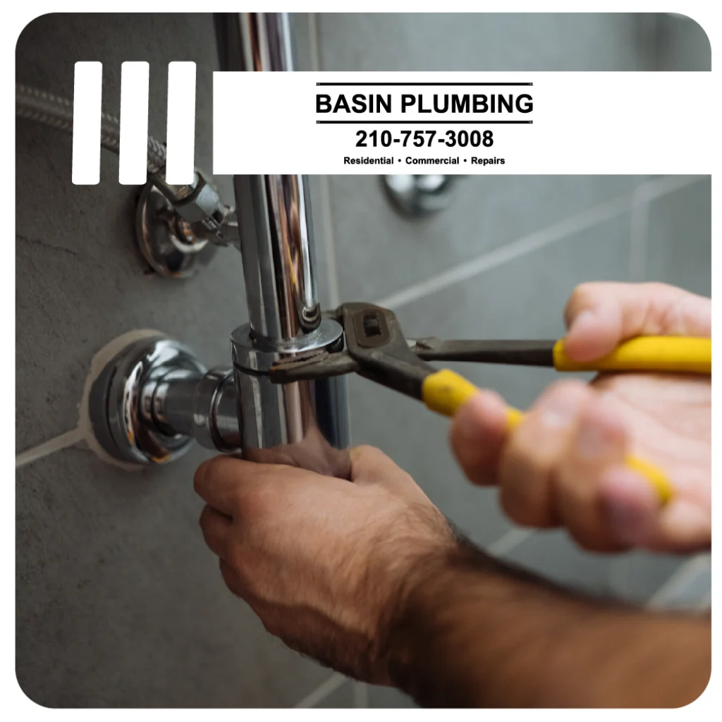 closeup of a plumber holding a wrench up against a pipe with the basin plumbing logo on the image